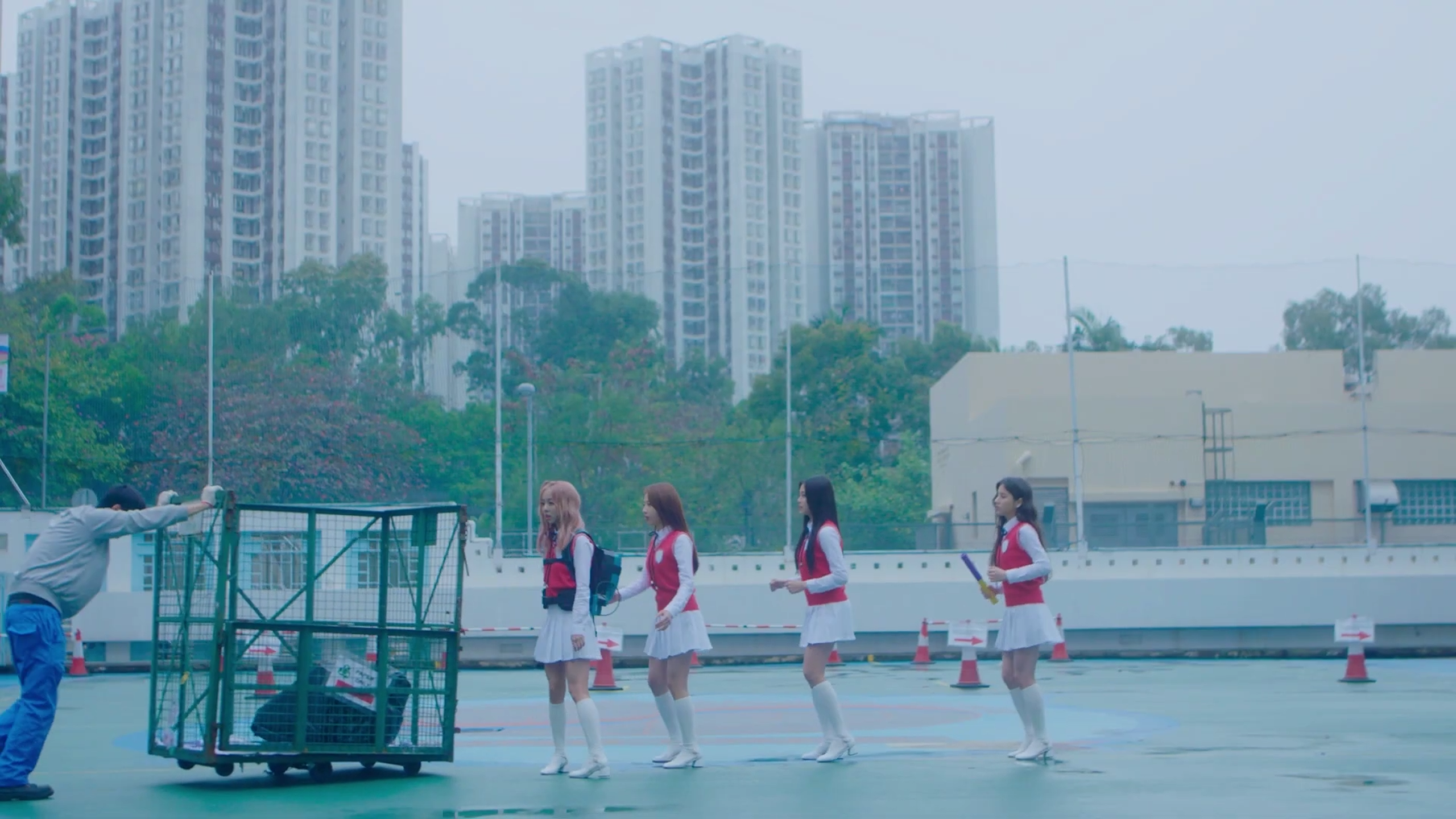 Loona One Third practicing together. Vivi is moving out of the way of a man pushing a cart.
